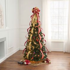 a decorated christmas tree with red and gold ribbons