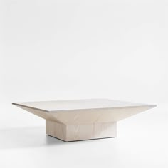 a wooden table with a white surface on the top and bottom, in front of a white background