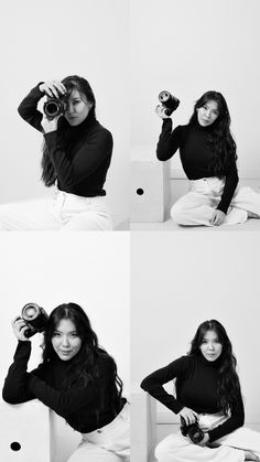 a woman sitting on top of a white bed holding a camera next to her face