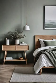 a bedroom with green walls and white bedding, wooden furniture and artwork on the wall