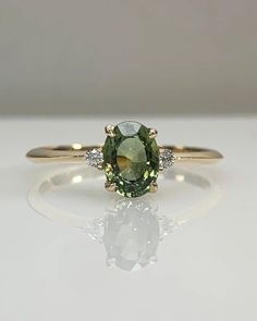 an oval green and white diamond ring