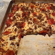 a pizza with pepperoni, sausage and cheese in a pan