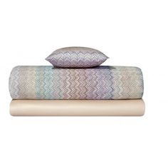 two pillows on top of each other with one pillow in the middle and another behind it