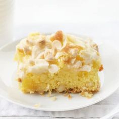 a piece of cake sitting on top of a white plate next to a glass of milk