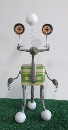 a metal robot with two golf balls on its head