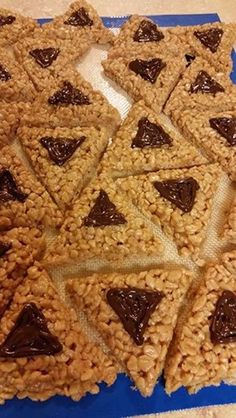 some cookies are arranged in the shape of triangles on a blue and white plate with brown icing