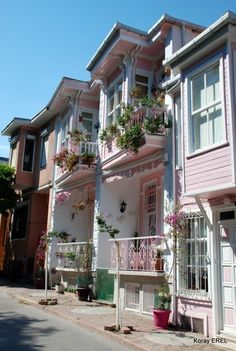 several pink and white houses with flower boxes on the balconies in san francisco, california