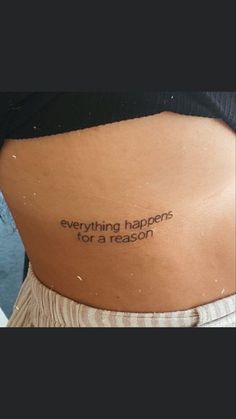 a woman's back with the words everything happens for a reason written on it