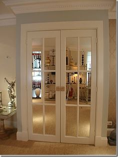 an empty living room with two glass doors