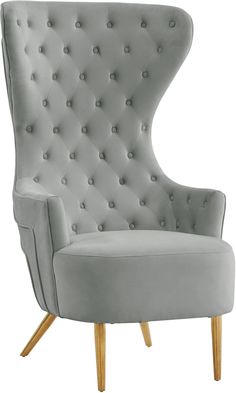 a grey chair with wooden legs and buttons on the back, sitting in front of a white background