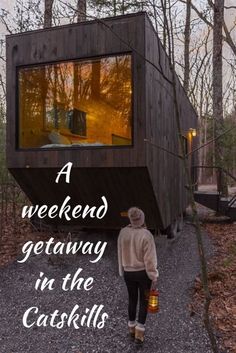 a woman walking towards a tiny house in the woods with text overlay that reads a weekend getaway in the catskills