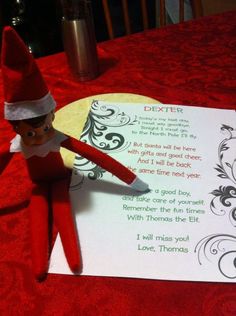 an elf with a pen sitting on top of a piece of paper next to a note