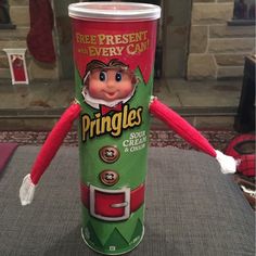 an elf is holding a cup with pringles on it