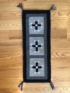 a black and white rug with four crosses on the front, two in the back