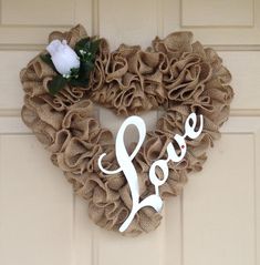 a heart shaped wreath with the word love on it