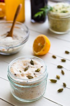 lemon zest sugar with cardamom in a glass jar next to an orange slice