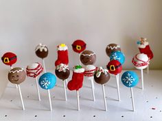 a group of cake pops with christmas decorations on them