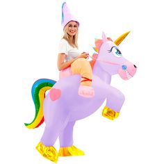 a woman riding on the back of a giant inflatable unicorn