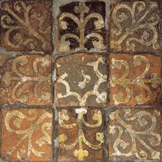 an old tile with different designs and colors on the floor, including brown, yellow and white tiles