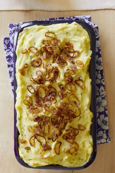 a casserole dish with mashed potatoes and bacon