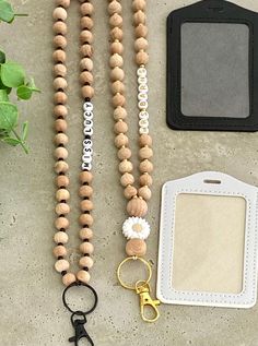 a wooden beaded lanyard, keychain, and cell phone case sitting next to each other