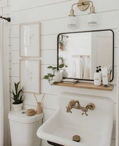 a bathroom with a sink, toilet and mirror