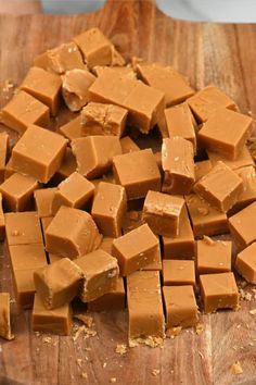 chopped up pieces of peanut butter on a wooden cutting board