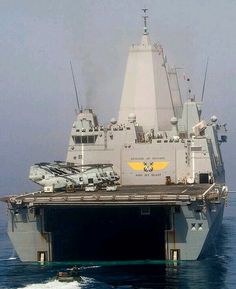 an aircraft carrier floating on top of the ocean