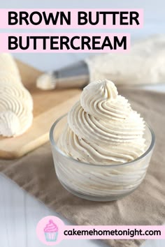 a bowl filled with whipped cream on top of a wooden cutting board next to a knife