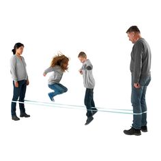 a group of people standing in front of each other with one person balancing on a tightrope