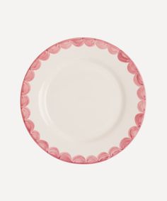 a pink and white plate with scalloped edges