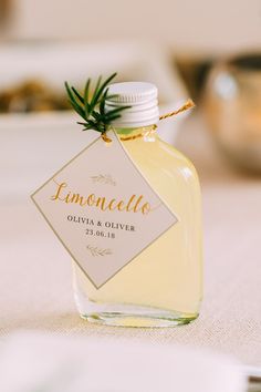 a bottle of lemoncello sitting on top of a table next to a napkin