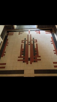 the floor is decorated with red, black and white tiles in an art deco style