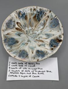 a blue and white plate with writing on it next to a note that says, i could't look at henry fluff