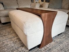 a couch with a wooden table on top of it in a room filled with furniture