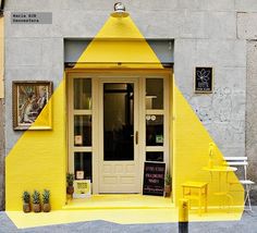 a yellow building with an open door on the outside