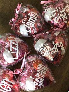 heart shaped candies are wrapped in cellophane and tied with pink ribbon on a table