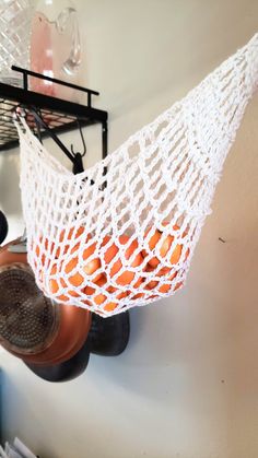 a white netted hammock hanging from a wall