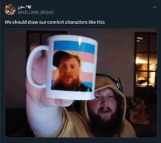 a man holding up a coffee mug with an image of a bearded man on it