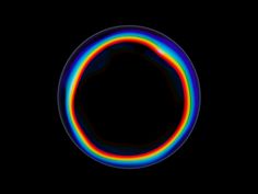 an image of a rainbow colored object in the dark