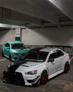 two cars parked next to each other in a parking garage