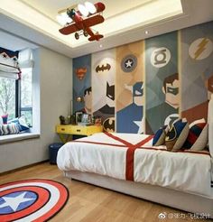 a bedroom decorated with captain america wallpaper and superhero themed bedding, along with a ceiling fan