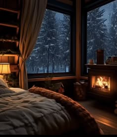 a bed sitting next to a window with a fire in the fireplace inside of it