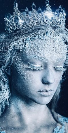 a woman with snow on her face wearing a tiara