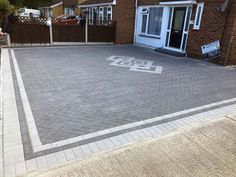 a brick driveway in front of a house