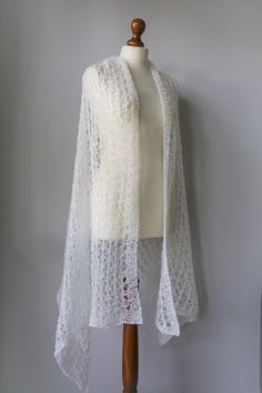 Are you a woman in search of the perfect shawl for your wedding day? Or perhaps you appreciate the beauty of handmade accessories and crave something truly unique. Look no further! My Handmade Crochet & Knitted Bridal Scarf is meticulously crafted to capture the essence of elegance and grace. Prepare to embark on a journey that will dramatically enhance your special day like no other scarf can. Specification: Measures: 76cm x 184cm Yarn composition: 62% Mohair, 38% Polyamide Color: pure white  !Notice!  To keep the scarf beautiful, soft and in perfect condition, you should only hand wash it in lukewarm water with a delicate soap. Don't use too much detergent. Don't use fabric softener. Don't iron. ⚙️ Impeccable Craftsmanship, Unmatched Quality Indulge in the ethereal charm of my hand-knitt Crochet Mohair, Bridal Scarf, Bridal Shawl, Lace Shawl, Walking Down The Aisle, Gift For Wife, Handmade Accessories, Shawls And Wraps, Pure White