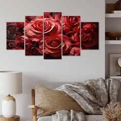 a living room with a couch, table and paintings on the wall in it's center