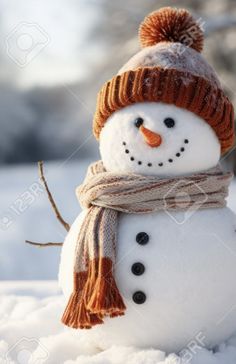 a snowman wearing a knitted hat and scarf in the snow stock photo - 957982