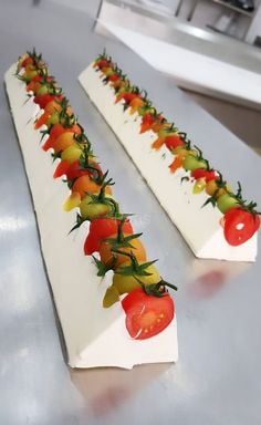 there are many different types of vegetables on this long serving platter that is ready to be served