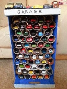 there is a garage display with cars on the front and back shelves in different colors